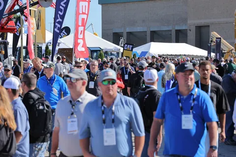 Visitors walking between equipment exhibits at The Utility Expo 2025