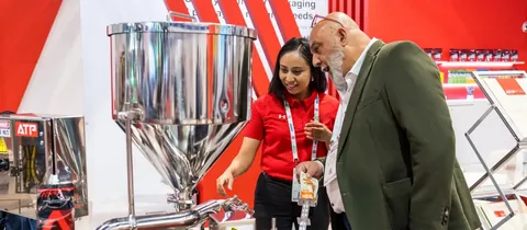 Archive photograph of a machinery discussion at PACK EXPO Las Vegas