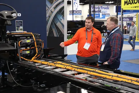 An exhibitor and attendee discussing equipment at Work Truck Week 2025