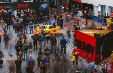 Archive view of visitors and vehicles on the SEMA Show floor