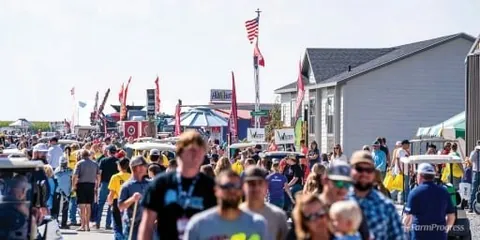 Archive photograph of visitors walking between Husker Harvest Days exhibits