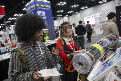 Visitors examining textile materials at Advanced Textiles Expo 2025
