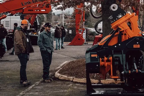 Archive photograph of visitors and forestry equipment at the Oregon Logging Conference